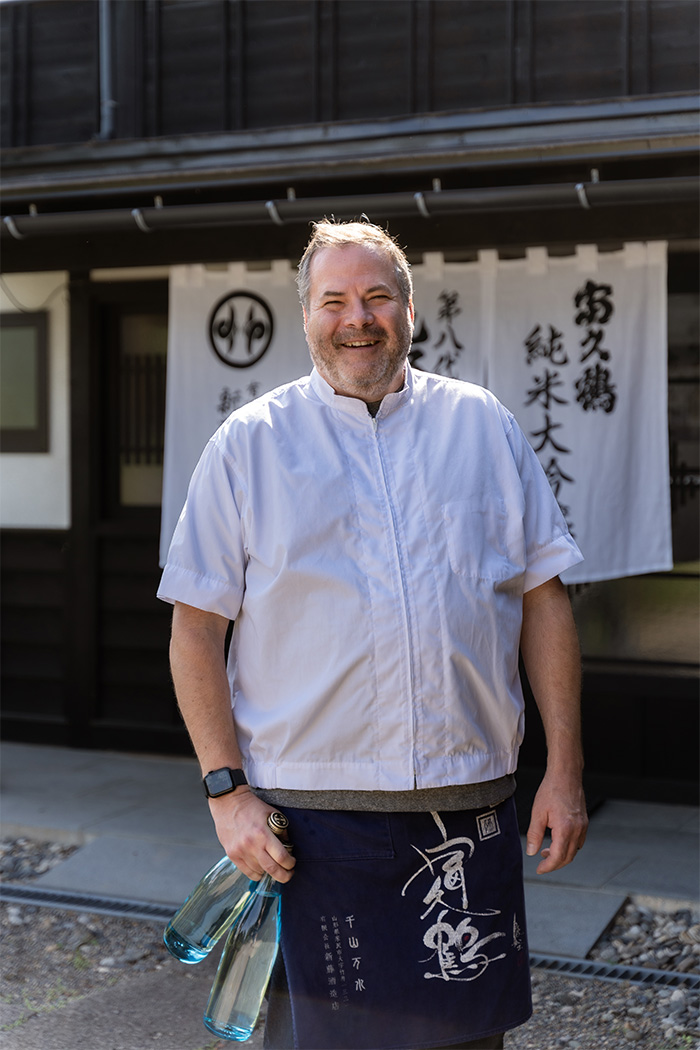 Stuart Morris holding bottles of sake